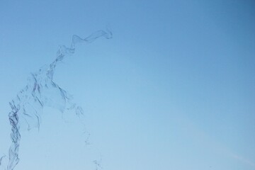 Soap bubbles on a blue sky illuminated abstract background with copy space 