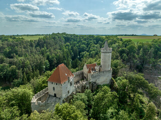 Fototapeta na wymiar Aerial view of Kokořín Kokorin Castle in Czechia Neo-gothic restauration of a hilltop ruined medieval fortress