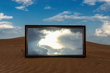 Reflection of the sky in the mirror in the desert.