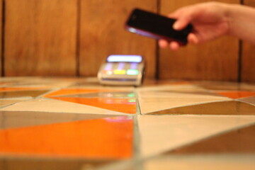 contactless payment phone pdq with hand holding credit card to pay