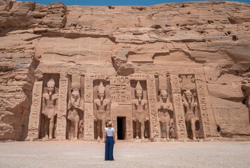 Young girl on her back enjoying the temple of Abu Simbel on her trip through Egypt. Temple of Queen...
