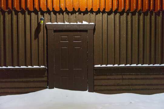 A snowy cabin door in the early winter morning in Minnesota
