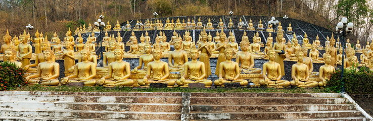 Multiple rows of golden statues of the Buddha at Wat Phou Salao, Pakse, Laos