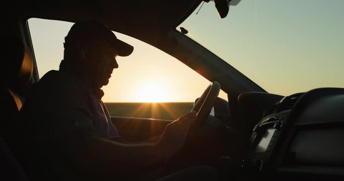 The angry driver is talking through the earpiece, gesticulating vigorously. Road accident concept
