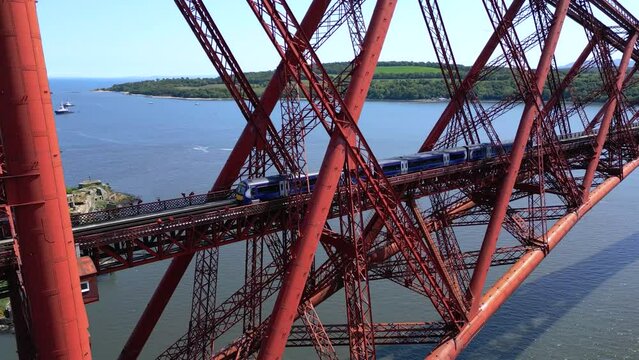 Trains pass in both directions over the Forth Rail Bridge in Queensferry, Scotland, UK