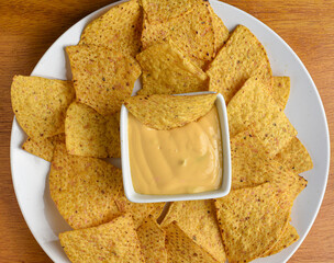 yellow corn chips served with a cheese dip