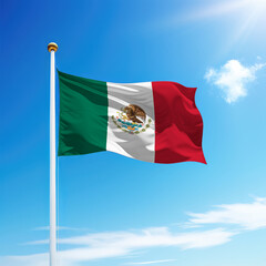 Waving flag of Mexico on flagpole with sky background.