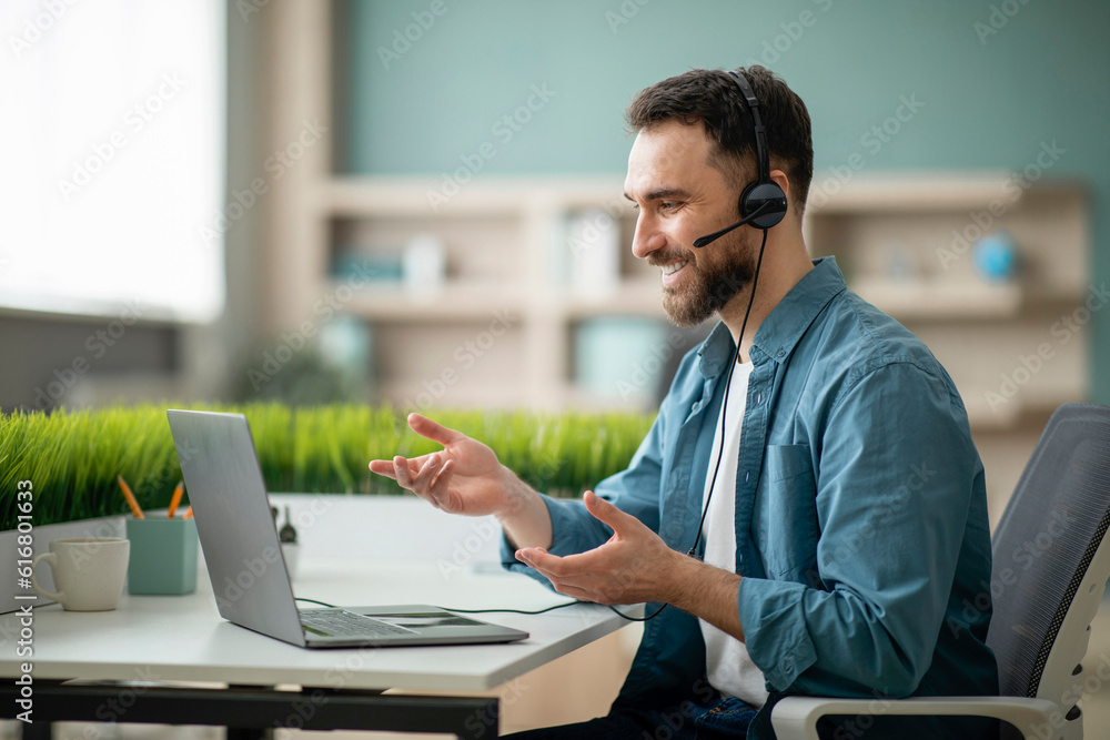 Poster video conference. smiling office employee in headset having web call on laptop