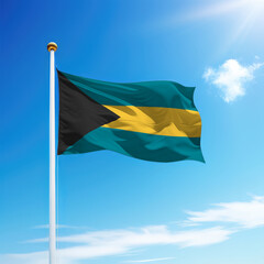 Waving flag of Bahamas on flagpole with sky background.