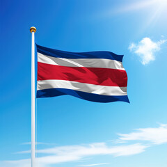 Waving flag of Costa Rica on flagpole with sky background.