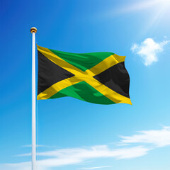 Waving flag of Jamaica on flagpole with sky background.