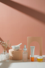 skincare and suncare with pestle and mortar and flower. horizontal with sunlight and shade.