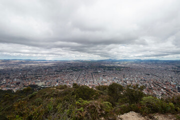 Bogota colombia cityscape sunny day viewed from a mountain with trekking path 