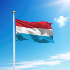 Waving flag of Luxembourg on flagpole with sky background.