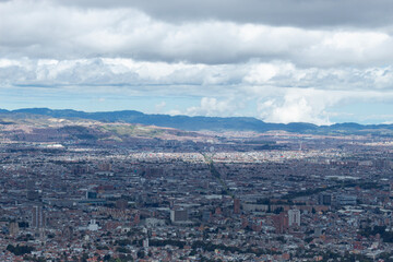 Fototapeta na wymiar Bogota landscape viewed from eastern mountains with andean mountain range at background