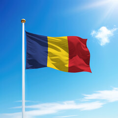 Waving flag of Romania on flagpole with sky background.
