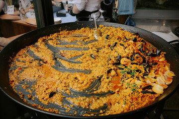 Seafood paella prepared on a street food market