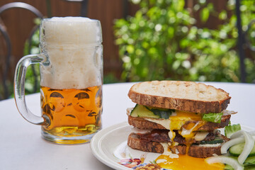 Close up picture of variation on Club sandwich with pint of czech pilsner beer, the best beer in...