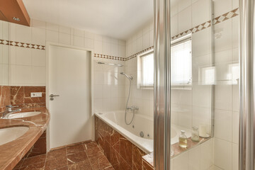 a bathroom that is very clean and ready for the guests to take their own bathtubs are in there