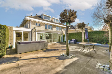 a backyard area with a table, chairs, and trees in the middle of the yard on a sunny day