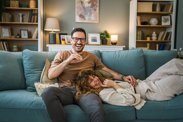 Couple caucasian man and woman sit at home on sofa bed watch tv movie