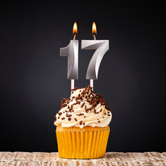 birthday cupcake with number 17 candle - Celebration on dark background