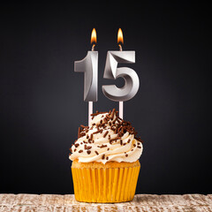 birthday cupcake with number 15 candle - Celebration on dark background