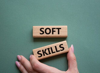 Soft skills symbol. Wooden blocks with words Soft skills. Beautiful grey green background. Businessman hand. Business and Soft skills concept. Copy space.