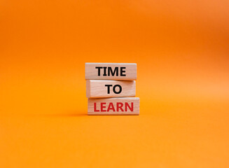 Time to learn symbol. Wooden blocks with words Time to learn. Beautiful orange background. Business...