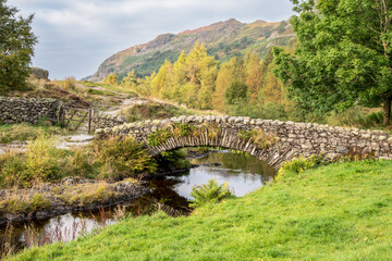 Fototapeta na wymiar Old pakhorse bridge in the Lake District