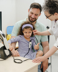 Child hearing test. Doctor audiologist examineing kids ear and assess disorder of hearing using...