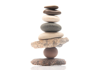 Fototapeta na wymiar pyramid of stacked stones on a white background. stabilization and balance in life