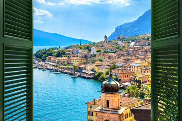 Window overlooking the village Limone Sul Garda on Garda Lake. The most famous tourist destination on lake. Lombardy, Italy.