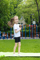 Kids Outdoor Fitness Circuit Summer Activity Games. Outdoor Activities for Kids. Little girl doing...
