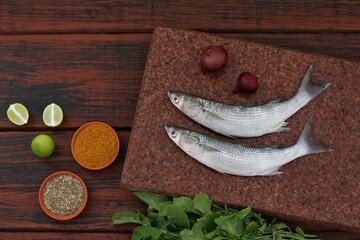 Sea fish mullet, Buri, Loban, on a wooden table, top view, background image, for presentations