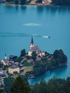 Aerial view of the church of Maria Worth (Maria Wörth) at Worthersee (Wörthersee) with boat