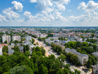 Power station at city suburbs, aerial view of tall chimneys