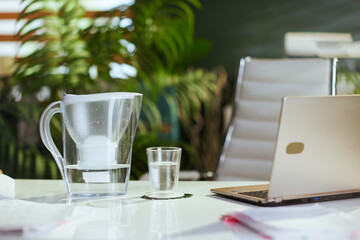 water filter and cup on table in modern office