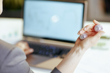 Closeup on modern business woman in grey business suit at work