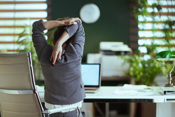 modern business woman in modern green office stretching hand