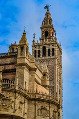 Fototapeta na wymiar 27.05.2023, Seville, Spain:'Cathedral de Sevilla' picture from the street. The cathedral, is open to public, you can see beautiful gothic style architecture unusually bright of the sunny weather