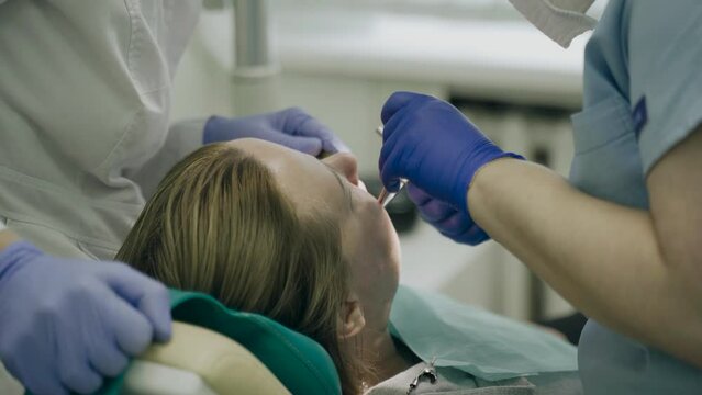 The dentist places a temporary filling on the tooth. Dental treatment.