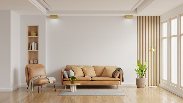 Living room wall mockup in bright tones with leather sofa and leather armchair.