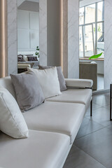 stylish bright modern bedroom interior with decorative niches with LED lighting and a huge panoramic window in gray and white colors and geometric shapes