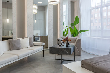 stylish bright modern bedroom interior with decorative niches with LED lighting and a huge...