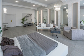 stylish bright modern bedroom interior with decorative niches with LED lighting and a huge...