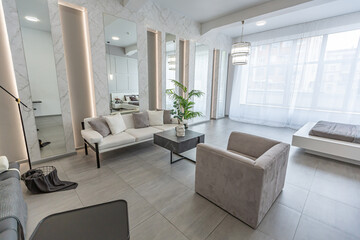 stylish bright modern bedroom interior with decorative niches with LED lighting and a huge...