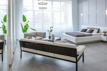 stylish bright modern bedroom interior with decorative niches with LED lighting and a huge...
