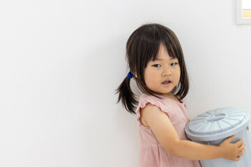 ゴミ箱を持って歩く女の子（2歳11か月、日本人）
