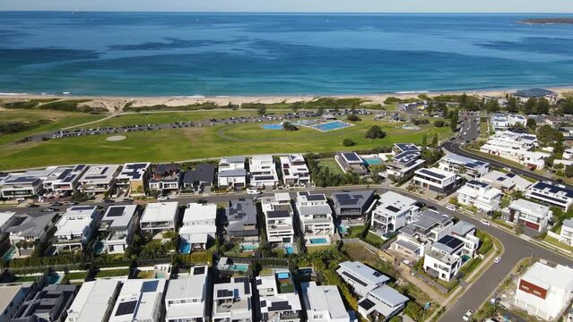 Aerial drone pullback reverse view of Cronulla looking toward Wanda Beach in the Sutherland Shire, Sydney, NSW Australia on a sunny day in June 2023 